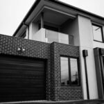 Stylish modern two-story house with architectural details in grayscale.